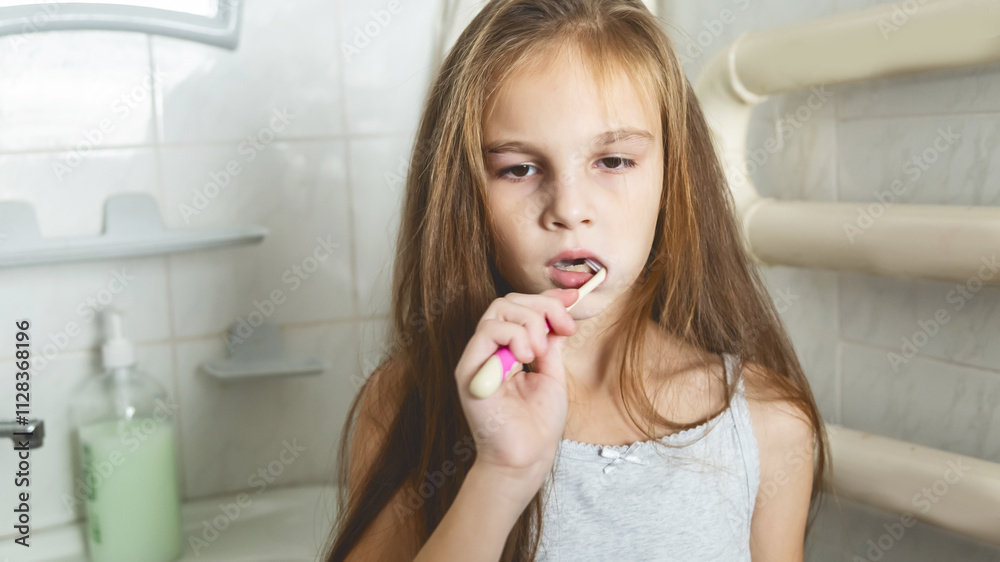 Portrait of child girl cleaning mouth with a toothbrush at bathroom Portrait of child girl cleaning mouth with a toothbrush at bathroom