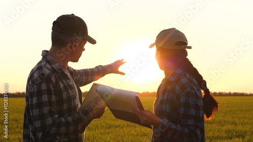 farmers cooperation. farmers wheat in field work discussion collaboration. farm with tablet and documents. teamwork in Agriculture