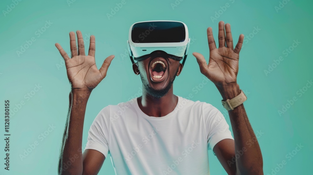 A young man wearing opaque virtual reality goggles, raising one hand to touch something A young man wearing opaque virtual reality goggles, raising one hand to touch something
