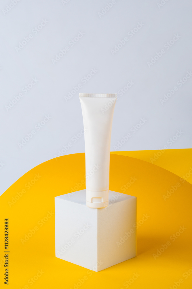 Cosmetic product in tube, bottle, lotion or serum on yellow background with stylish props. Cosmetic product in tube, bottle, lotion or serum on yellow background with stylish props.