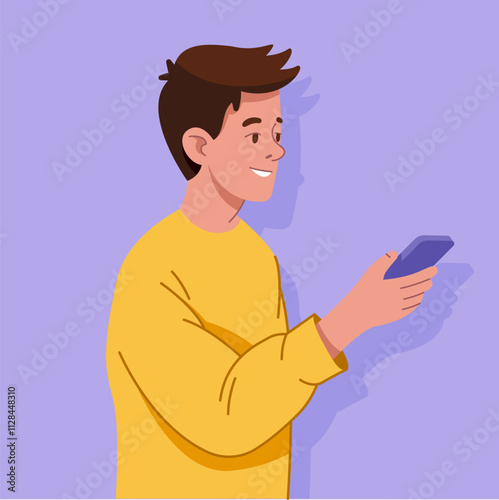 A young man wearing a yellow sweater, standing and holding a cell phone in his hand. He appears to be looking at the screen of the phone, possibly checking messages or browsing the internet.