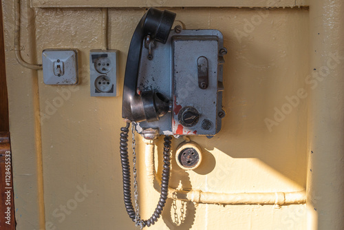 фотографія an old-fashioned communication device, a shipboard telephone, mounted on a metal