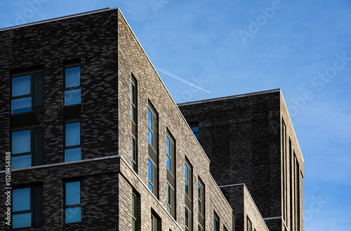 brick and glass facade with plane