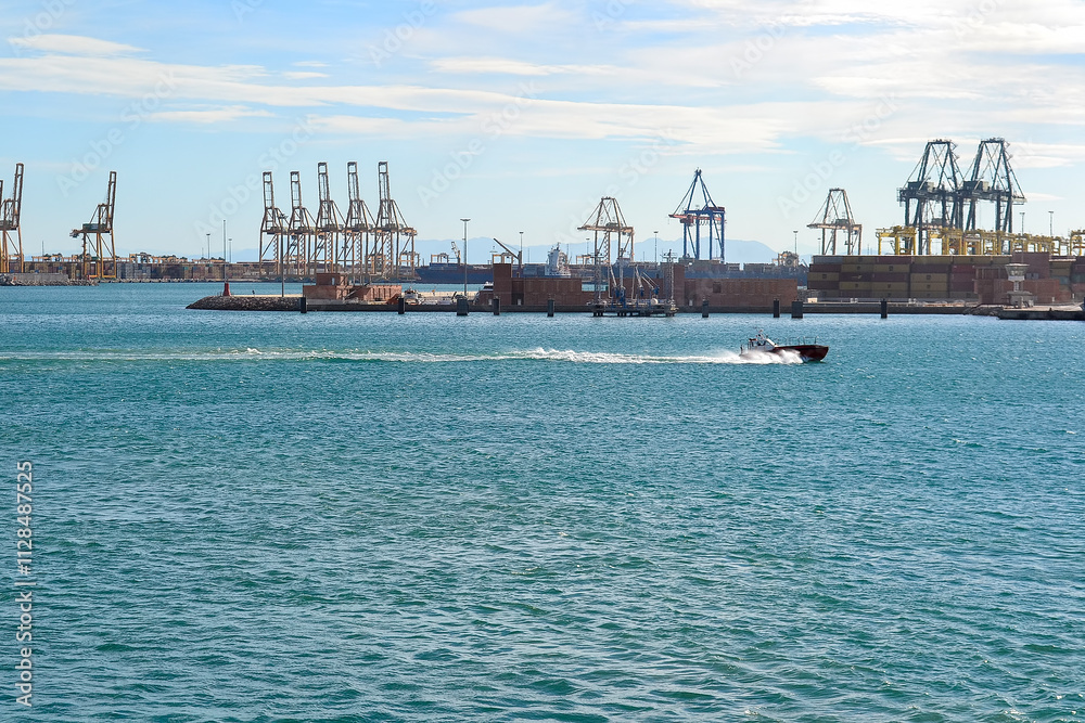 Naklejka premium Bustling Port Scene with Cranes and Motorboat in Valencia, Spain