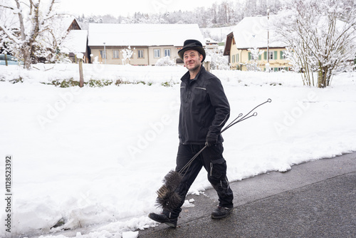 Chimney Sweep Walking Through Snow-Covered Neighborhood In Winter photo