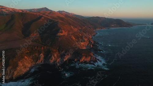 Sunset scenic vista aerial drone Big Sur California Santa Lucia Mountains rugged coastline Apple Computer Silcone Valley screensaver Bixby Big Creek Pfeiffer Canyon Pacific Ocean forward pan right photo