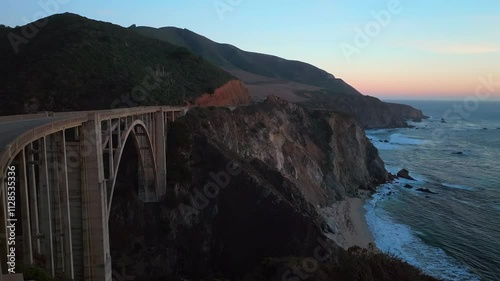Bixby Bridge sign Big Creek Pfeiffer Canyon Santa Lucia Mountains Big Sur California aerial drone sunset birds Pacific Ocean Coastal Highway windy road rugged coastline Carmel Sea Monterey backwards