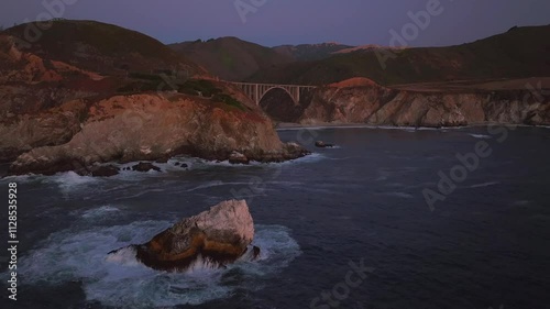 Rugged Big Sur coastline Bixby Bridge Big Creek Pfeiffer Canyon Santa Lucia Mountains California aerial drone stunning dusk sunset Pacific Ocean Coastal Highway windy road waves crashing static motion photo