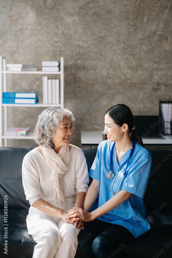 Fototapeta premium Asian caregiver doctor examine older patient woman therapist nurse at nursing home taking care of senior elderly woman sit on sofa