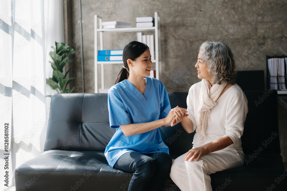 Asian caregiver doctor examine older patient woman therapist nurse at nursing home taking care of senior elderly woman sit on sofa Asian caregiver doctor examine older patient woman therapist nurse at nursing home taking care of senior elderly woman sit on sofa