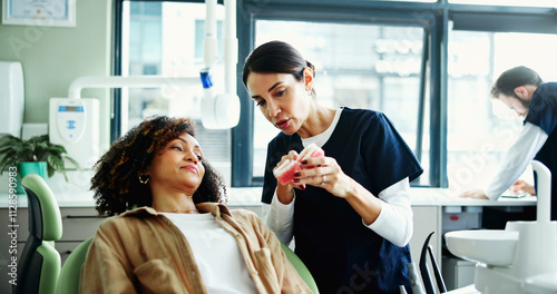 Consulting, mouth model and dentist with woman in clinic for cleaning, dental hygiene and demonstration. Healthcare, dentistry and patient with hygienist for extraction, oral care and medical service