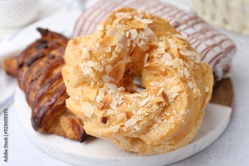 Different sweet pastries on light table, closeup