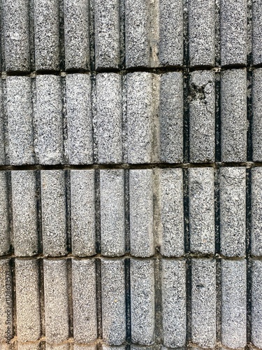 Image of a wall of oval brick blocks arranged in layers.