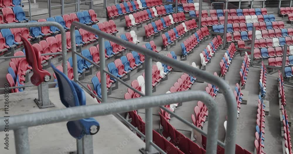 Dynamic shot of empty stands in a modern football stadium of Górnik Zabrze with red, blue, and white seats in Poland, 4K Dynamic shot of empty stands in a modern football stadium of Górnik Zabrze with red, blue, and white seats in Poland, 4K