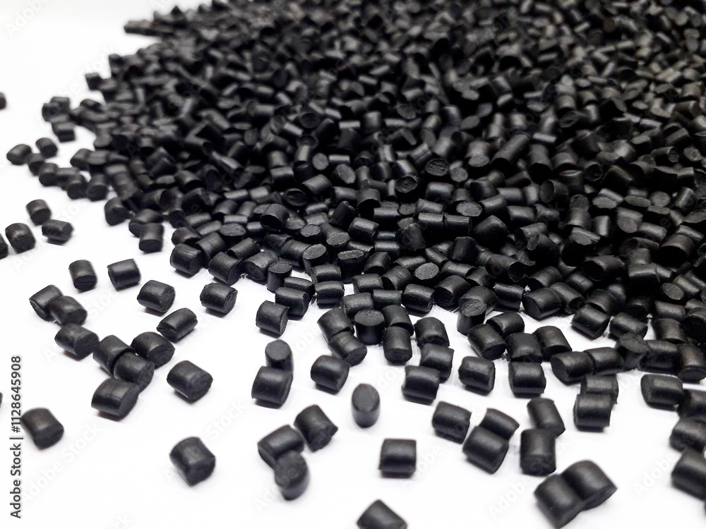 Black masterbatch granules on white background, polymer carrier of color pigment in plastic industry. Suitable for plastic company catalog design. Black masterbatch granules on white background, polymer carrier of color pigment in plastic industry. Suitable for plastic company catalog design.