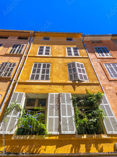 Bild auf Leinwand Yellow facade of a French building in Aix en Provence