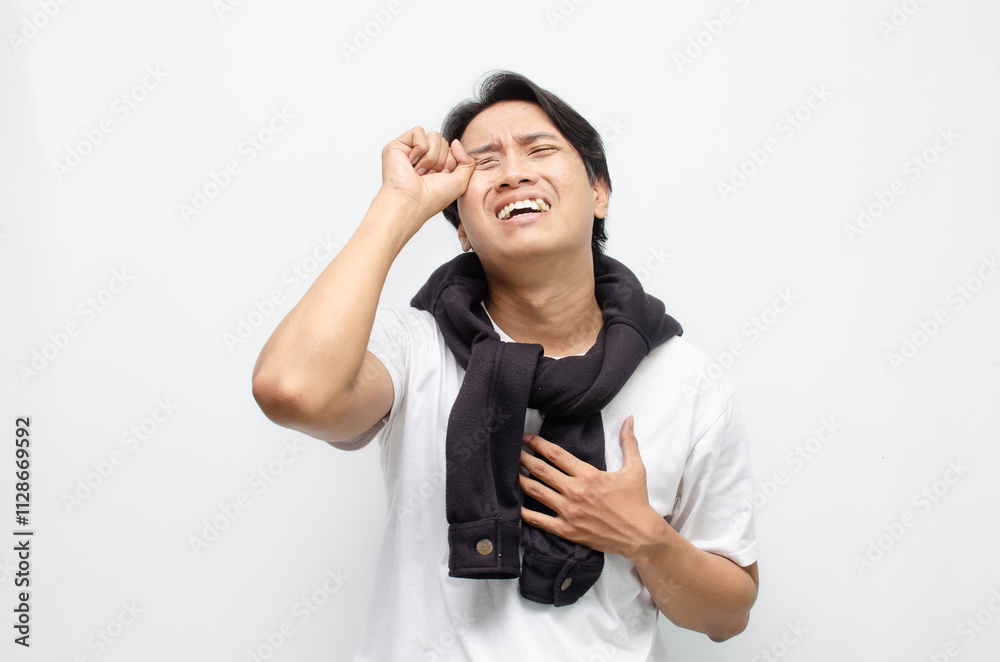 Young Asian Man Crying with a Sad Expression, Showing Deep Emotions Young Asian Man Crying with a Sad Expression, Showing Deep Emotions