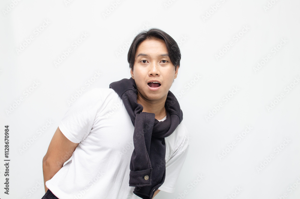 Happy and Surprised Young Asian Man in Casual Outfit Celebrating Victory Happy and Surprised Young Asian Man in Casual Outfit Celebrating Victory