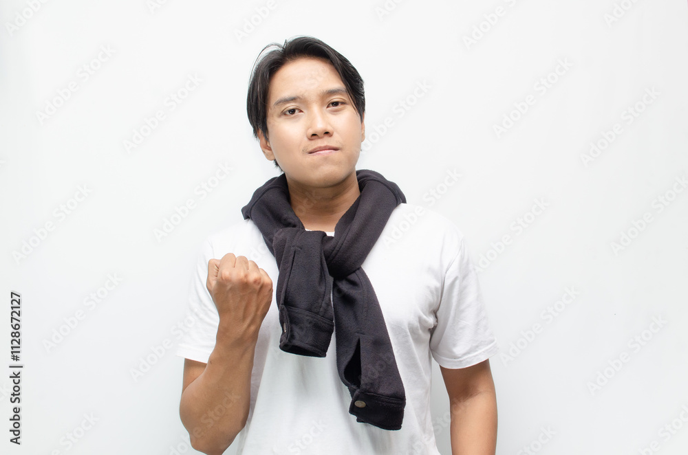 Happy and Surprised Young Asian Man in Casual Outfit Celebrating Victory Happy and Surprised Young Asian Man in Casual Outfit Celebrating Victory