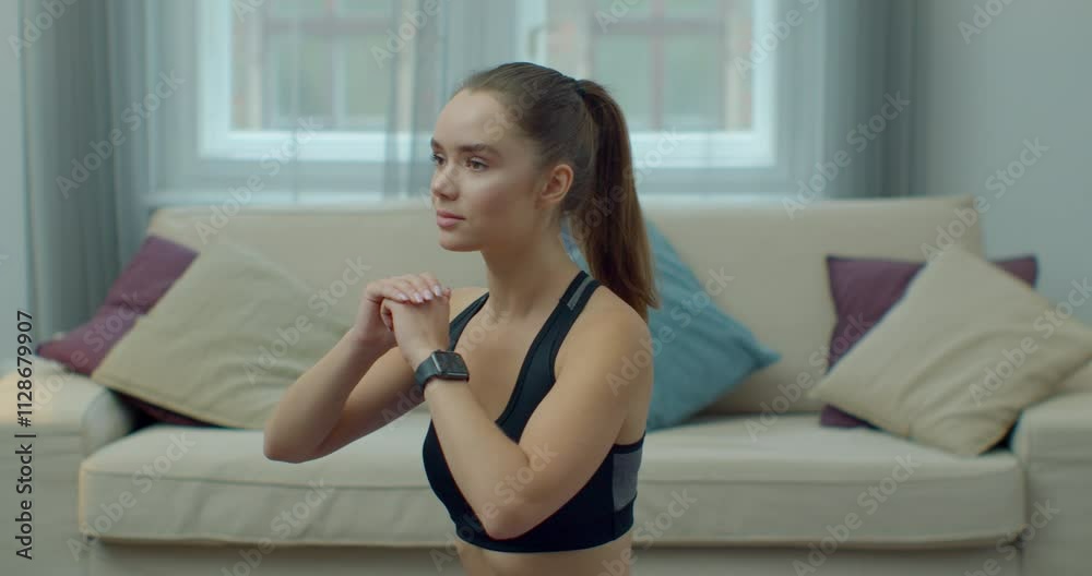 Woman is doing squats exercise at home. Females aerobics sport fit at home slow motion. Workout, training, wellness, sport concept. Woman is doing squats exercise at home. Females aerobics sport fit at home slow motion. Workout, training, wellness, sport concept.