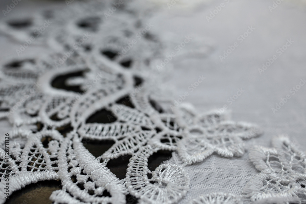 Embroidery pattern on a white table cloth, abstract detailed backdrop Embroidery pattern on a white table cloth, abstract detailed backdrop