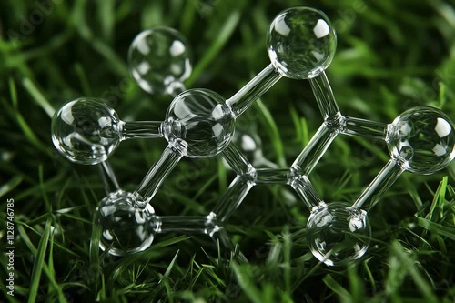 Visualization of levomenol or bisabolol molecule: a natural monocyclic sesquiterpene alcohol employed in scents on a green grass background	 photo