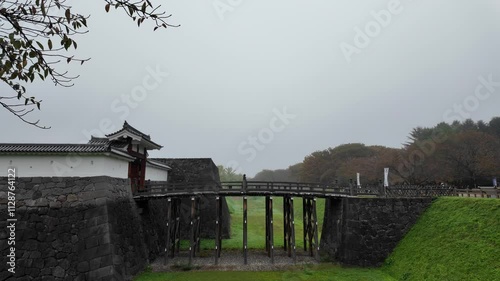 Kajo park, Historic castle with a wooden bridge in misty landscape photo