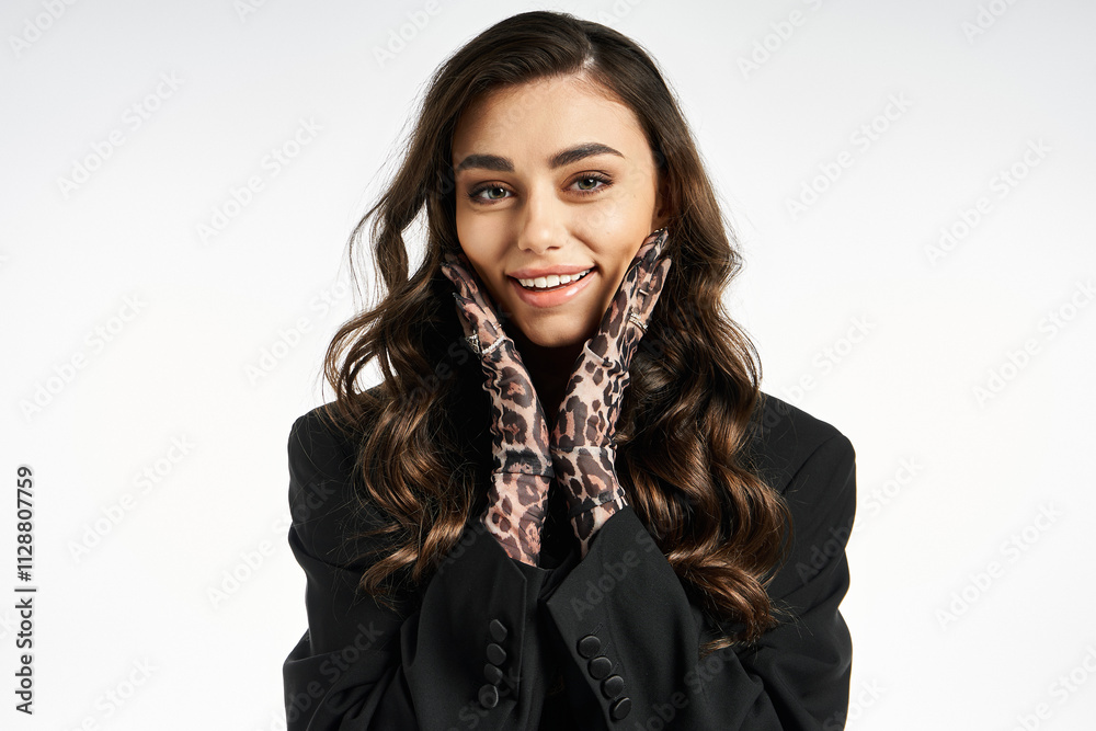 A trendy young woman showcases her playful side with stylish gloves and a radiant smile. A trendy young woman showcases her playful side with stylish gloves and a radiant smile.