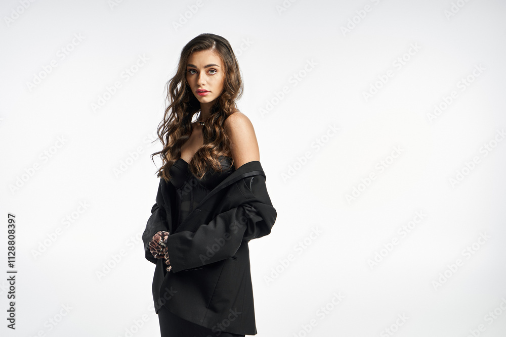 A young woman stands confidently, dressed in a striking black ensemble, exuding charm and grace. A young woman stands confidently, dressed in a striking black ensemble, exuding charm and grace.