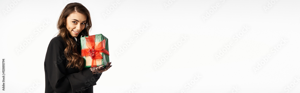 Bright eyed woman holds a colorful present while sharing holiday cheer and excitement indoors. Bright eyed woman holds a colorful present while sharing holiday cheer and excitement indoors.