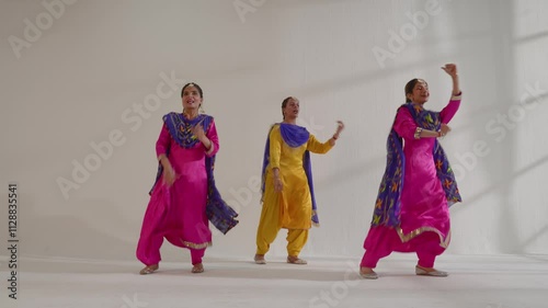 Three Sikh Women performing bhangra during Baisakhi celebration