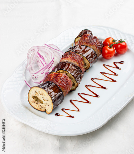 Tender pork kebabs served with roasted eggplant slices.