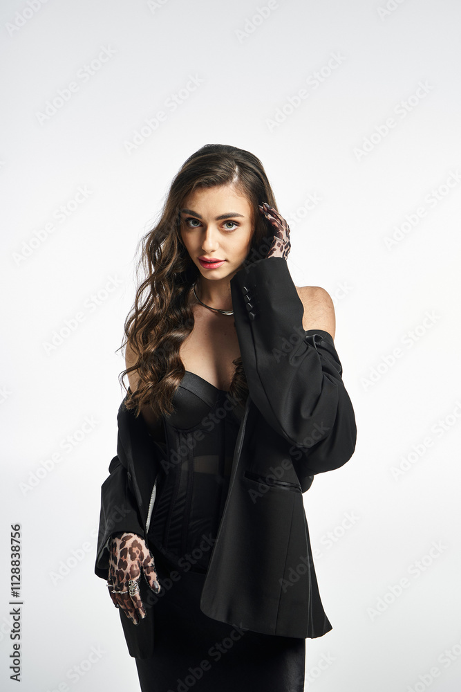 Young woman showcases fashion confidence in a striking ensemble with unique accessories.
