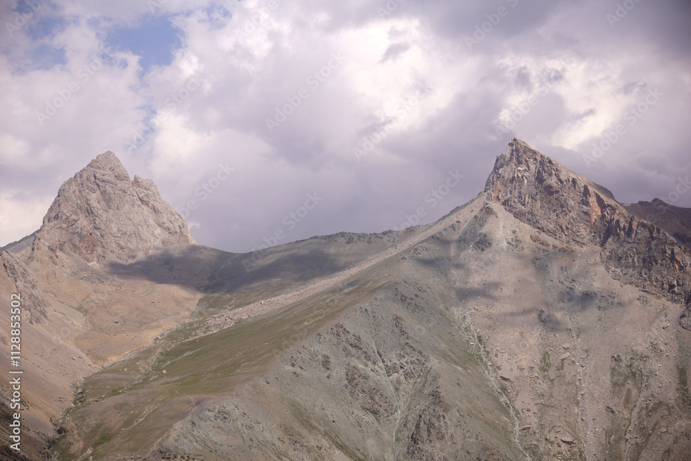 a mountain pass between two pointed peaks a mountain pass between two pointed peaks