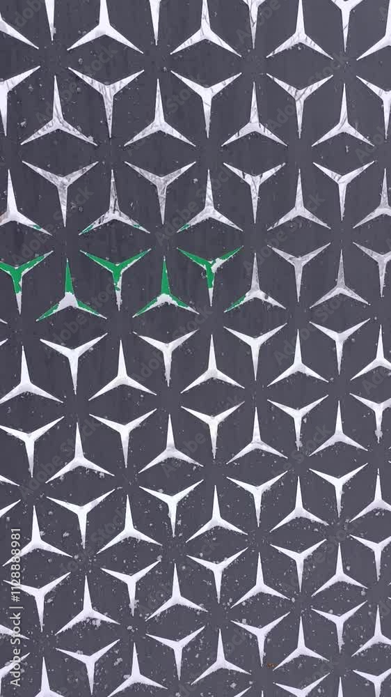 A black and white pattern with green accents on a wall