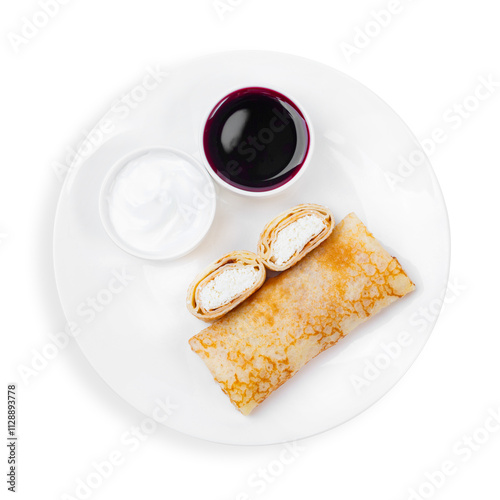 Pancake with cottage cheese, sour cream and jam, on a plate, top view, on a white background, isolated.