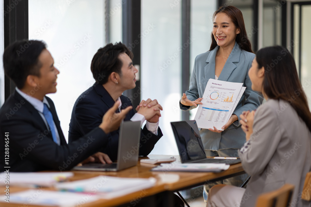 Asian businesswoman leader discussing business planning idea presentation with colleagues in conference room at office. Asian businesswoman leader discussing business planning idea presentation with colleagues in conference room at office.