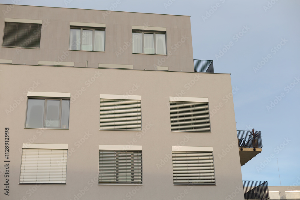 There is a structure featuring a balcony situated at the very top of it, enhancing its architectural appeal and exterior design features