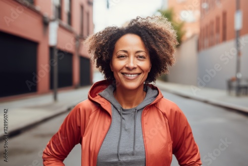 Portrait of a middle aged body positive African American woman in sporty clothes outside