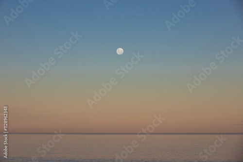 Luna llena sobre el mar en Golfo Nuevo, Playa El Doradillo, Chubut, Argentina photo