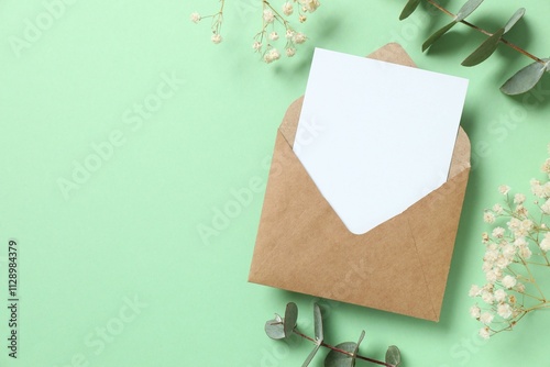 Paper envelpe with eucalyptus branches. Empty greeting card for text design photo