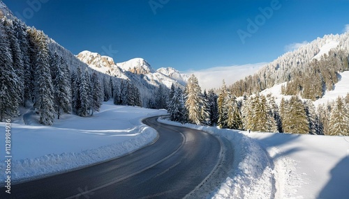 curved road in the italian alps in south tyrol during winter sunny winter day with harsh shadows and lot of snow photo