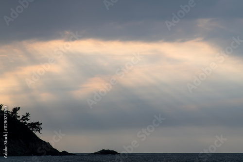 sunshine coming down from the sky to the sea photo