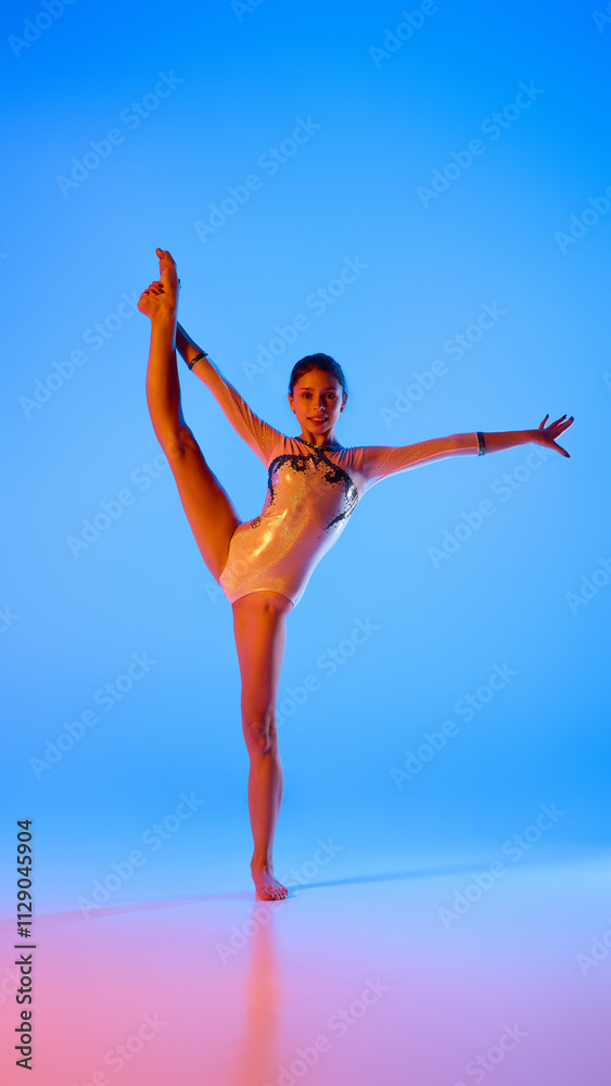 Fototapeta premium Strength and elegance,. Young gymnast balances gracefully, perfecting each move in pink neon light against gradient blue background. Concept of professional sport, active lifestyle, hobby. Ad