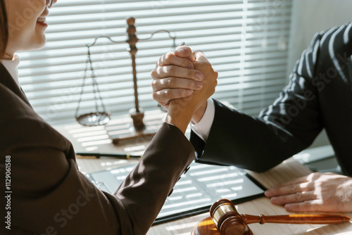 Two lawyers arm wrestling in their office after signing a contract, demonstrating their competitive spirit and determination