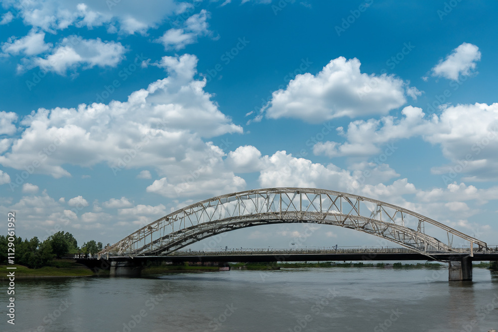 A bridge over a river. A bridge with clouds and a river in the sky. Blue bridge in the nature with blue sky. Blue sky and clouds over the bridge in lifestyle nature. A bridge over a river. A bridge with clouds and a river in the sky. Blue bridge in the nature with blue sky. Blue sky and clouds over the bridge in lifestyle nature.
