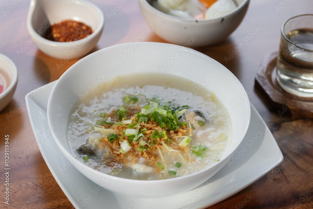 Rice congee with soft-boiled egg flavor with pickled chili vinegar and ground dried chilies Rice congee with soft-boiled egg flavor with pickled chili vinegar and ground dried chilies