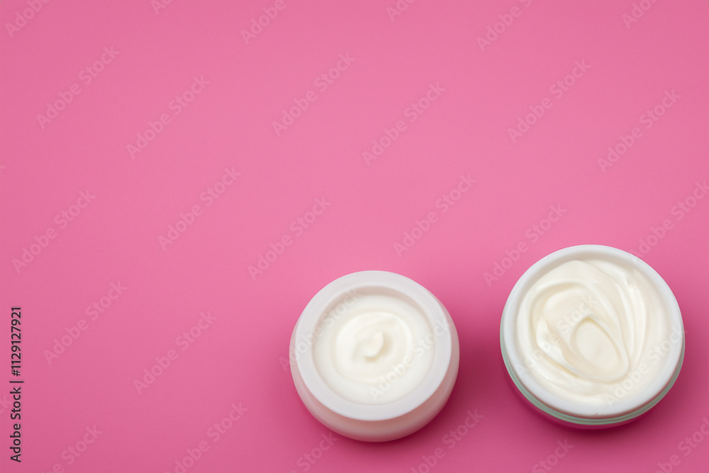 Two jars of cream on background. Jar of creme with background. White and pink cream bottle with a pink background. A pink jar of cream and a white background with a lifestyle pink jar.
