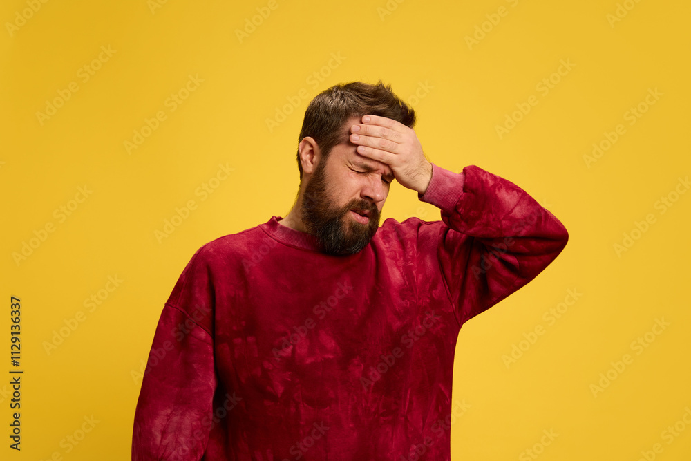 Portrait of man dressed casually putting hand on head as he felt fever against bright yellow background. Viruses and symptoms. Concept of healthcare,, medicine, health insurance. ad Portrait of man dressed casually putting hand on head as he felt fever against bright yellow background. Viruses and symptoms. Concept of healthcare,, medicine, health insurance. ad
