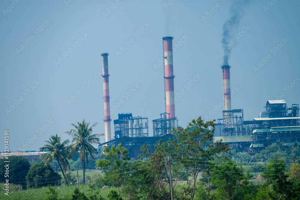 Obraz premium sugar mill, sugar factory in India, A sugar cane mill is a factory that processes sugar cane to produce raw sugar or plantation white sugar. Increasing air pollution to factory smoke.